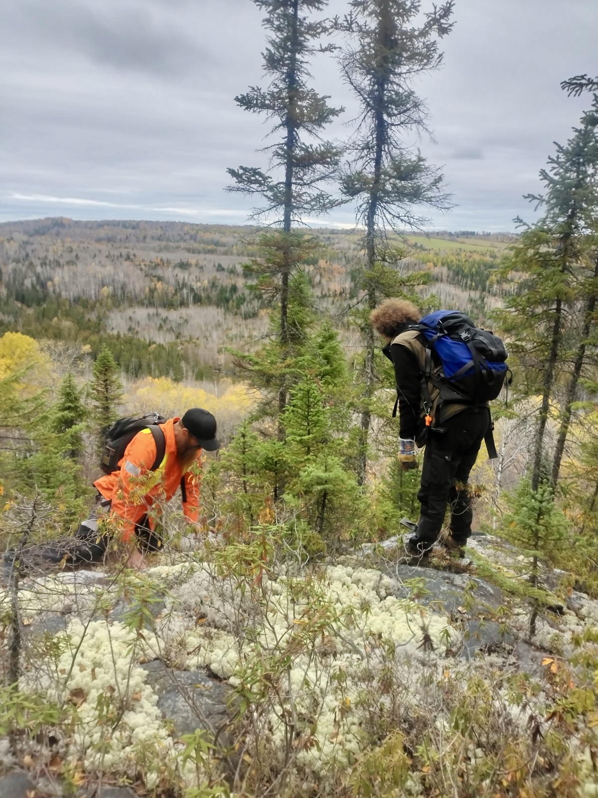 Prospector examining outcrop in the field
